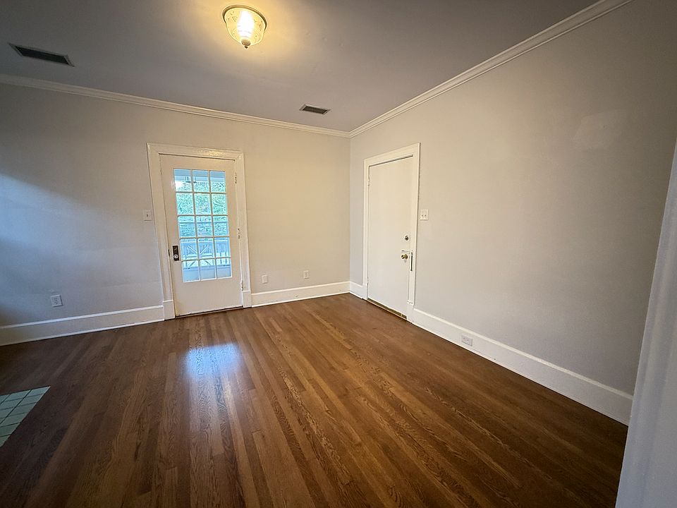 This is your first peek inside the space. The solid door opens to the interior public hallway. The glass door opens to the balcony.