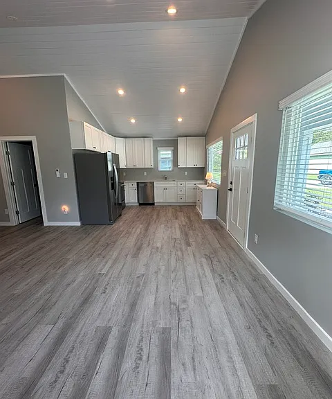Upgraded, custom shiplap ceilings throughout with large front windows for natural lighting