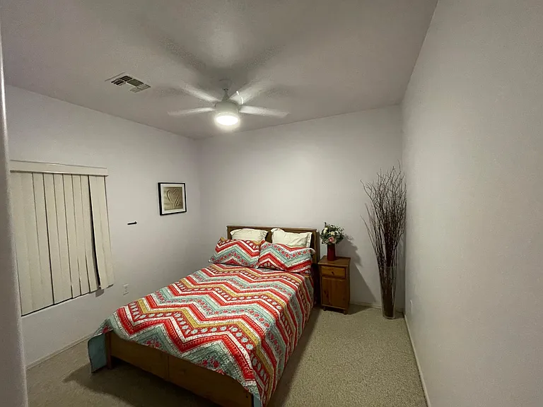 Third bedroom that fits a queen size bed and includes a ceiling fan