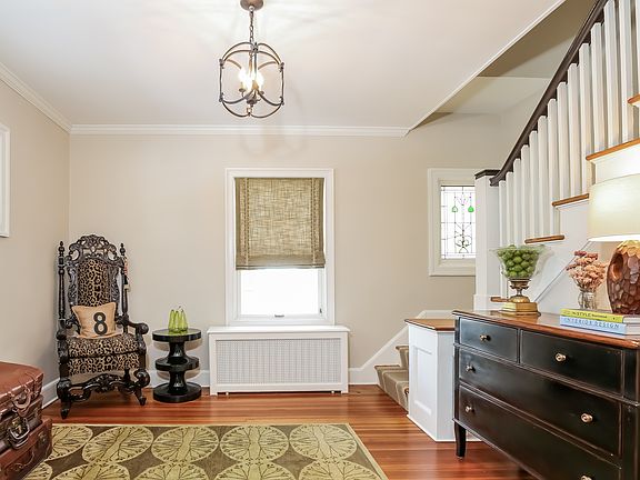 The gracious entry foyer w/ stained glass window.