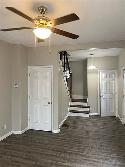 Living room with a coat closet next to entrance