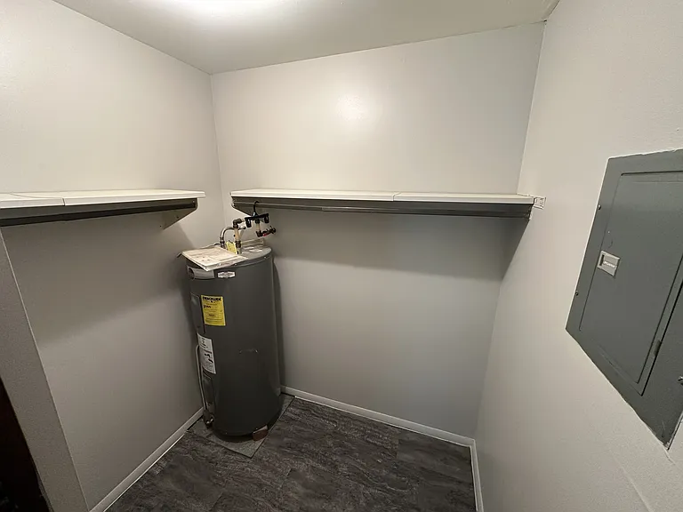 Closet with water heater and electrical panel