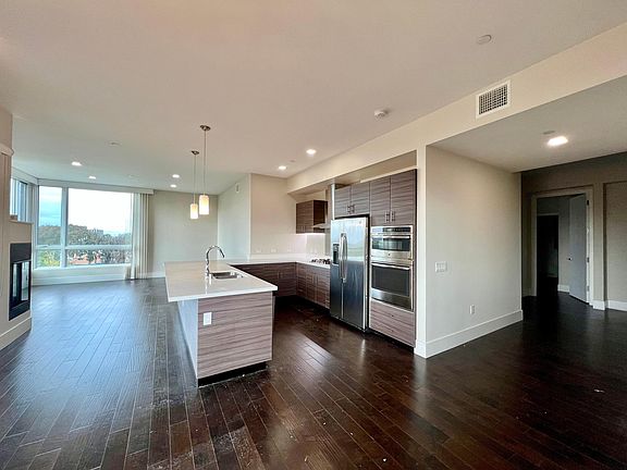 View from Dining space into Kitchen, Living and Hallway to Bedrooms