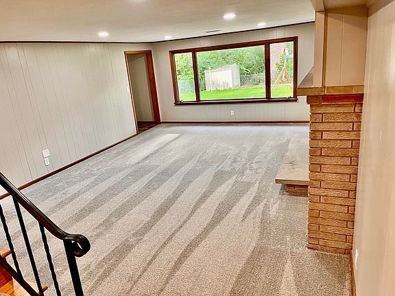 Lower level family room. Huge window to backyard guarantees the room is flooded with light.
