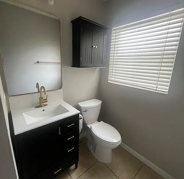 Guest View #2: Vanity with sink & faucet, mirror, vanity light and above toilet storage.