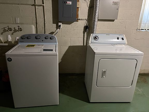 Tenant's laundry facilities in basement next to entry foyer.