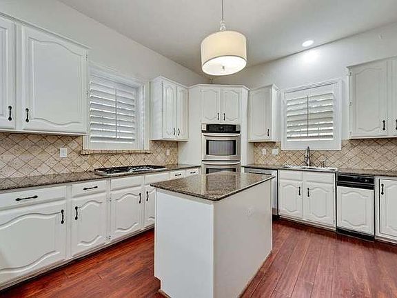 Kitchen sink has a lovely view of the front yard with its lush landscaping