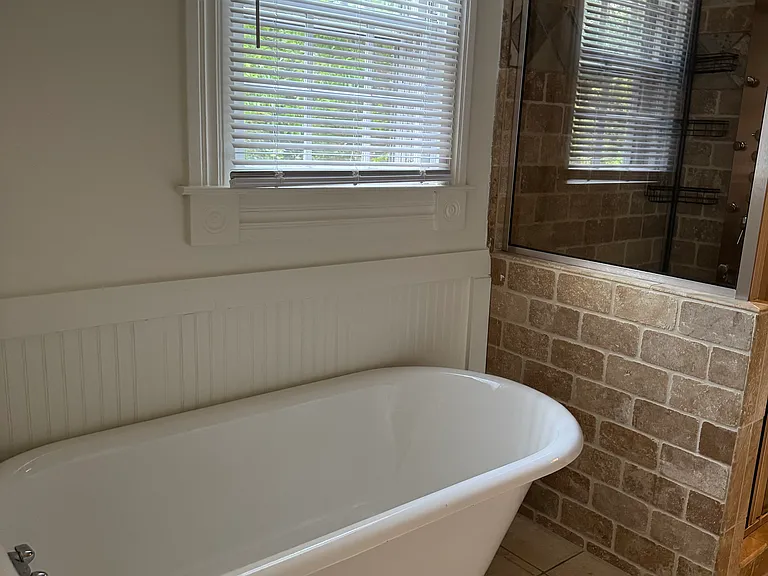 Upstairs bathroom tub w/ window.