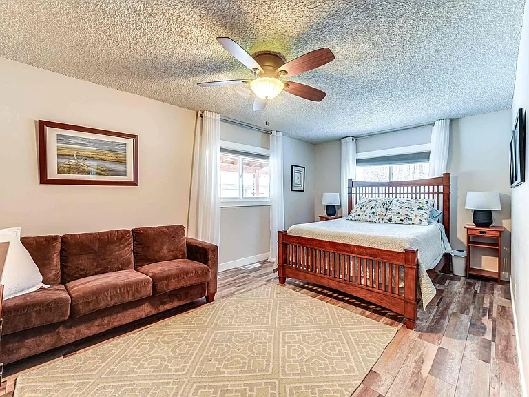 Upstairs queen bedroom with closet and sitting area. Includes TV and Roku for streaming.