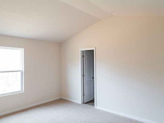 Master bedroom features high ceilings, private bath and walk-in closet