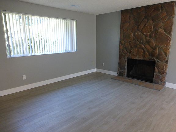 Large living room with floor to ceiling wood burning fire place