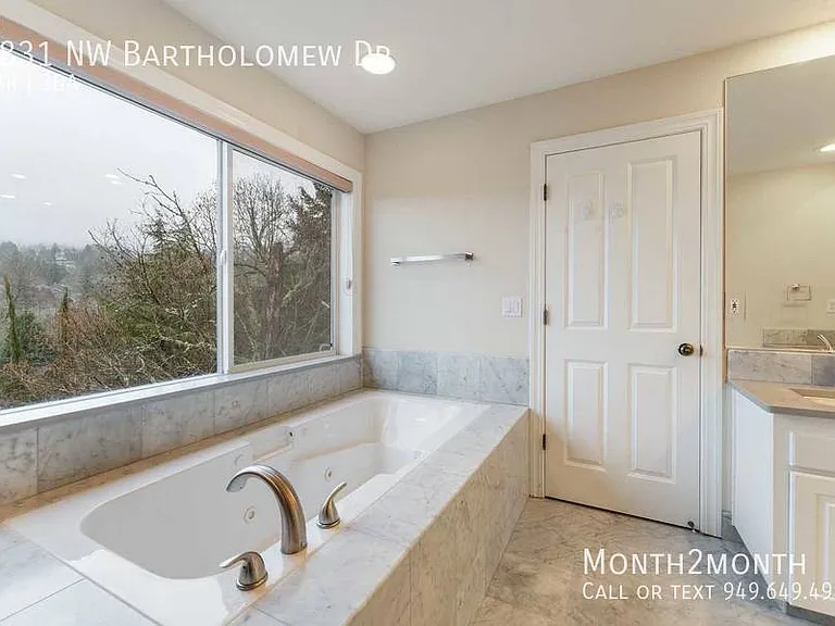 9831 NW Bartholomew Dr — Photo 23
