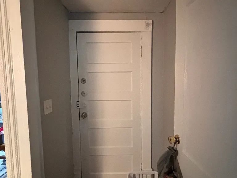 Door leading to Back Stairs. New Luxury Vinyl Tile.