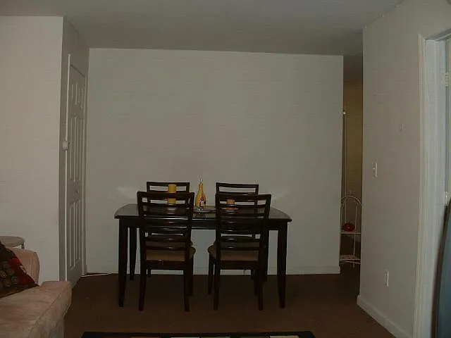 living room looking towards front, closet and dining area, s