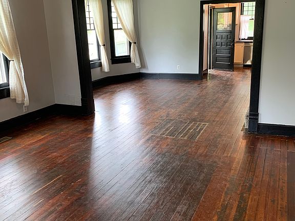 Large living room with hardwood floors and ceiling fan