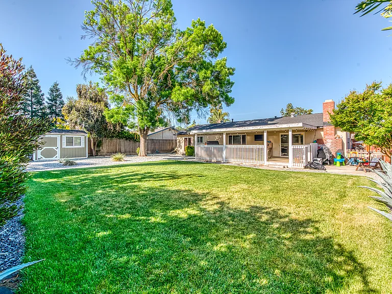 Large backyard perfect for a family. Area off the patio is perfect for a grill.
