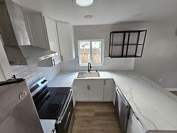 Kitchen with quartz countertops and subway backsplash tiles.