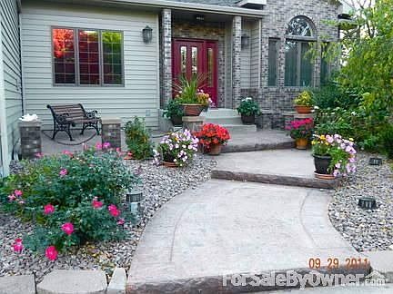 Front Entry
						:
						Front entry with decorative concrete off circular drive. Beautiful landscaping.