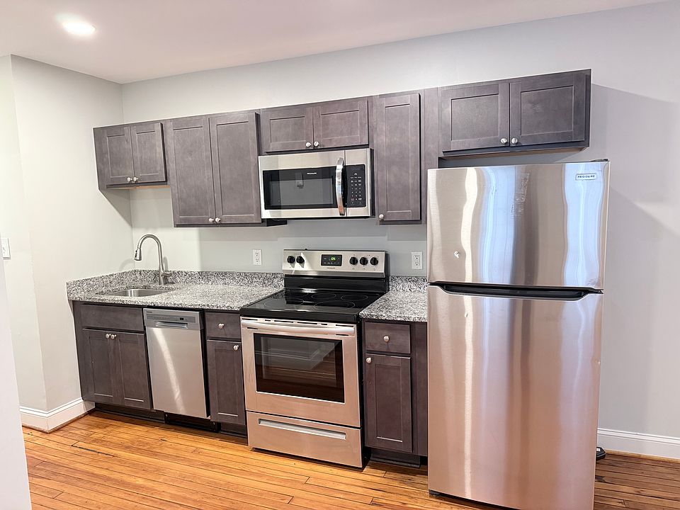 Galley Kitchen with dishwasher, microwave, range and refrigerator with ice maker
