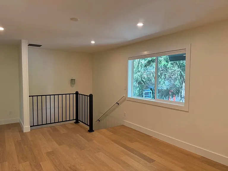 View from opposite side of living to the stairs which go to 2 beds and 1 bath on the lower level