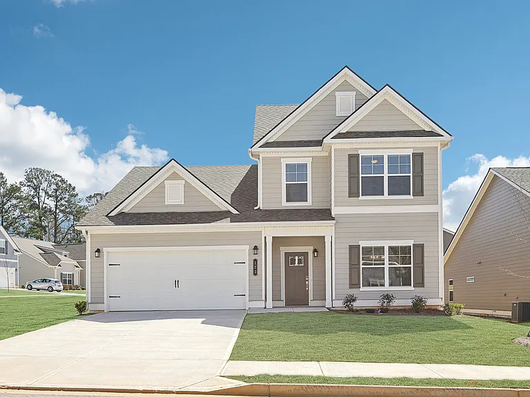 Exterior of the Wilmot, two story home with a private driveway and attached garage.