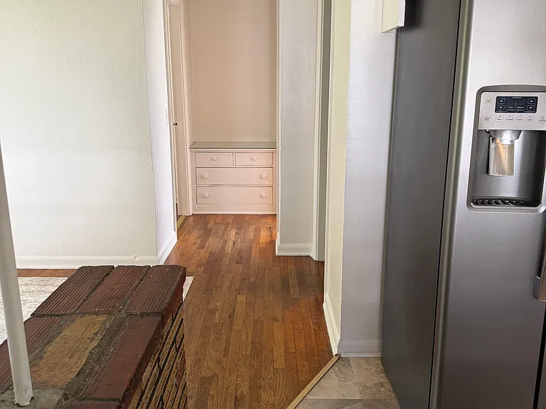 Hallway to bedrooms and bath. Built-in at end of hallway.