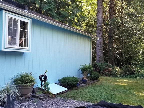 Side yard with backyard woods view.