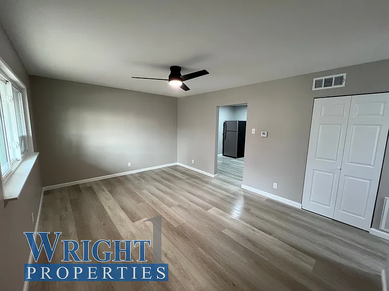 Front entry way view - Doorway leading into kitchen and showing coat-closet located in front room area.
