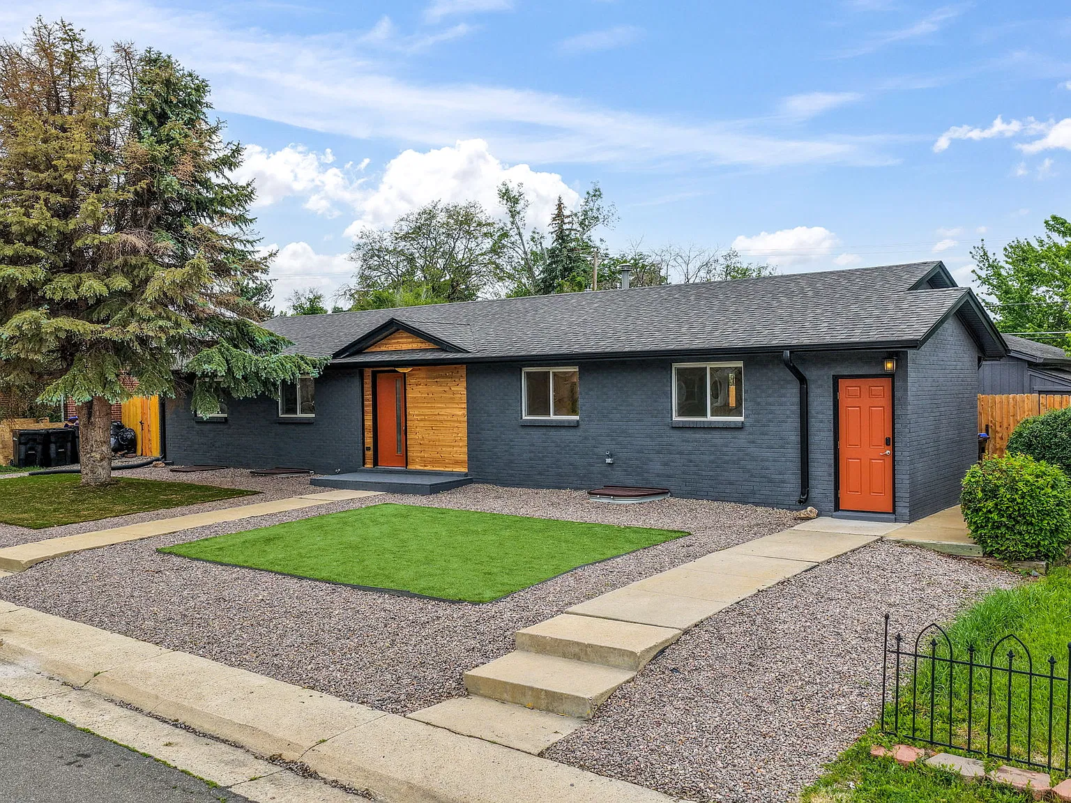 Center door is the front entrance to the home. Door on right is entrance to basement unit.