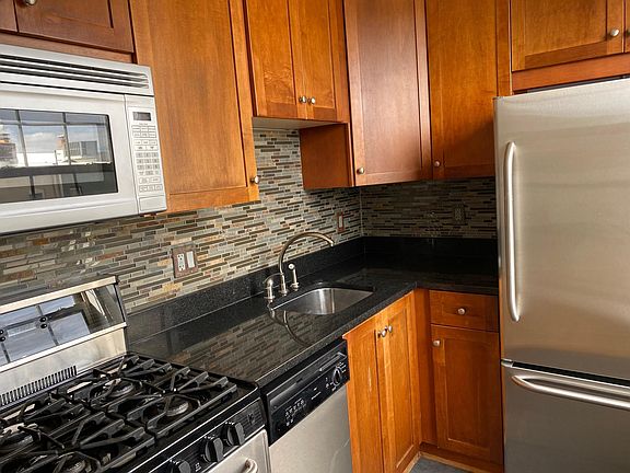 Update kitchen with stainless steel appliances and tile backsplash.