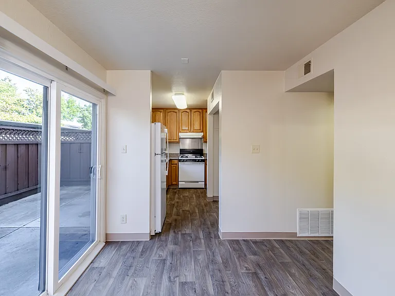 Bright dining area with sliding glass doors that open to a private patio.