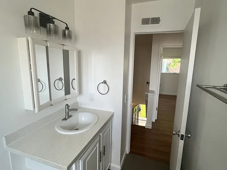Updated tub/shower bath. Quartz countertops, extra storage mirror, updated light, fixtures and tile.