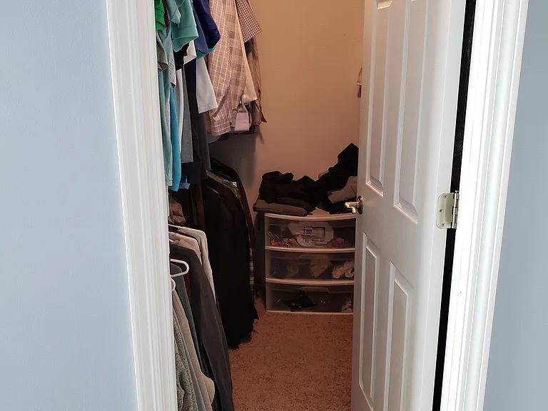 Walk in closet, master bedroom. Has closet organizers on both sides.