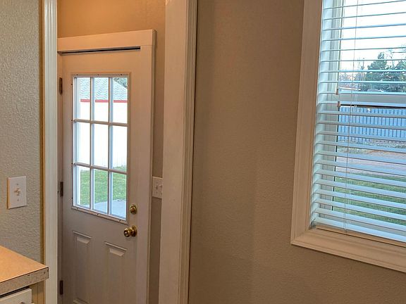 Stairway off kitchen to lower level and back yard