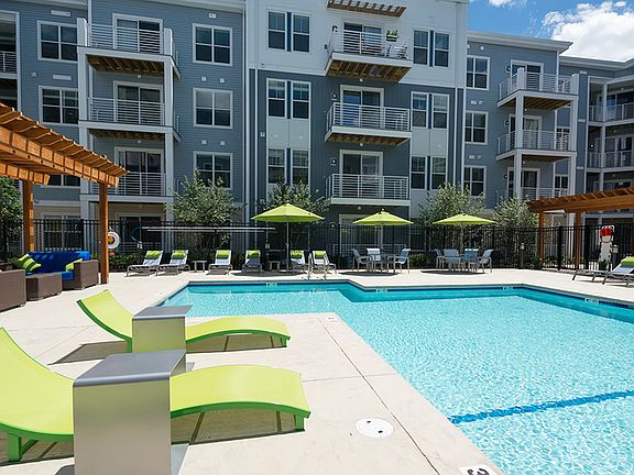 Lounge poolside with drink in hand