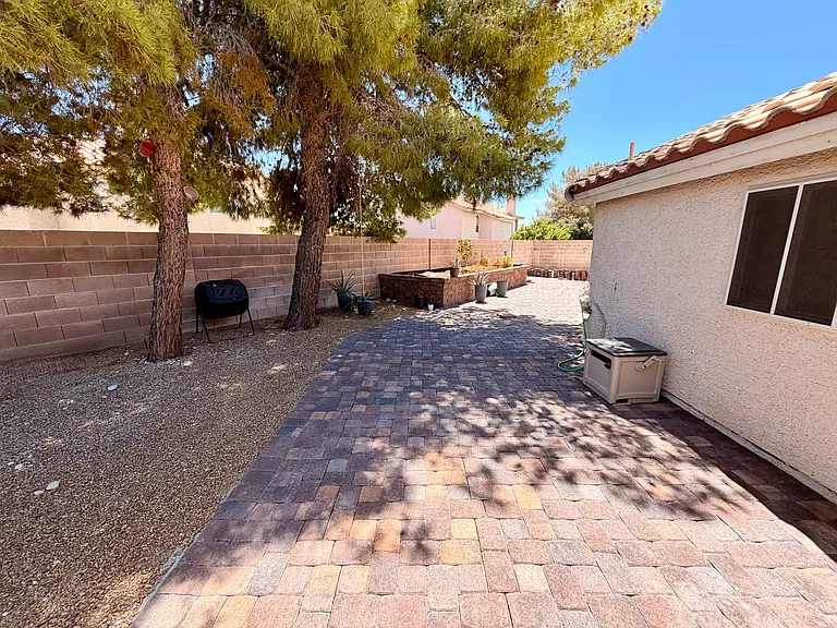 Backyard looking towards raised garden, RV parking.