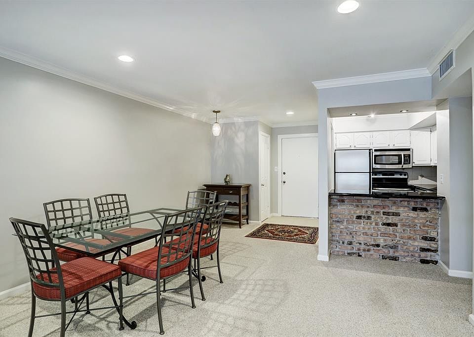 Spacious dining area with recessed lighting. Kitchen opens to living area through the breakfast bar.