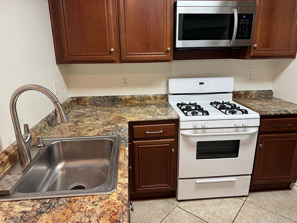 Like new cabinets and roller bearing drawers, custom counter tops and tile flooring