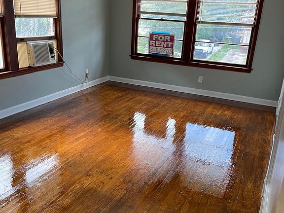 Living Room, Restored Original Hardwood floors, new remote controlled ceiling fans. Window Unit AC/Heat newer energy efficient for zoned cooling and heating.