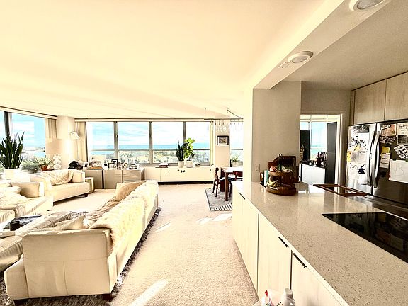 view of living room, dining area and kitchen