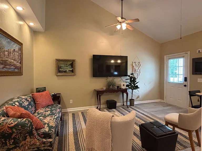 Soaring ceilings in this living room. Can see the smart TV from the kitchen, too!