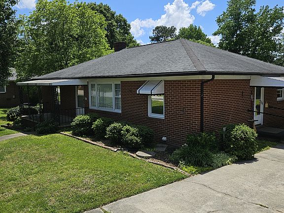 Home features a private paved driveway for convenient off-street parking with easy access to kitchen for unloading groceries.