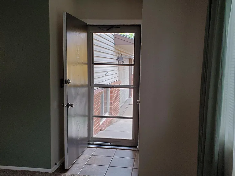 Front entry way/front door. Tile and carpet have been replaced with new luxury vinyl flooring.