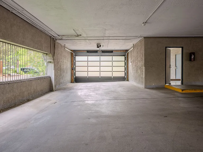 Garage is fully secured with bars and remote-control garage door