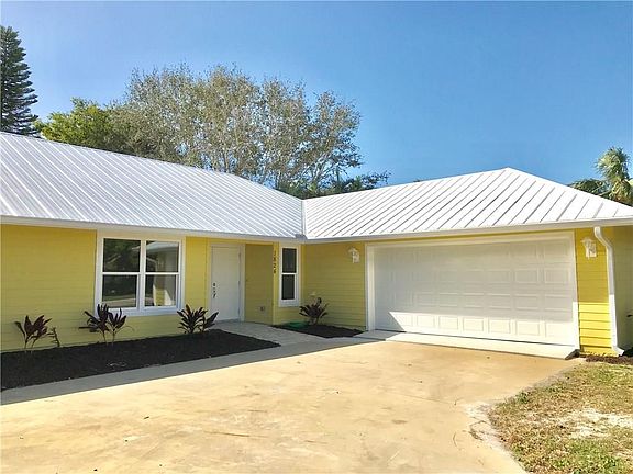 Another front view showcasing side-entry double car garage with auto garage door opener.