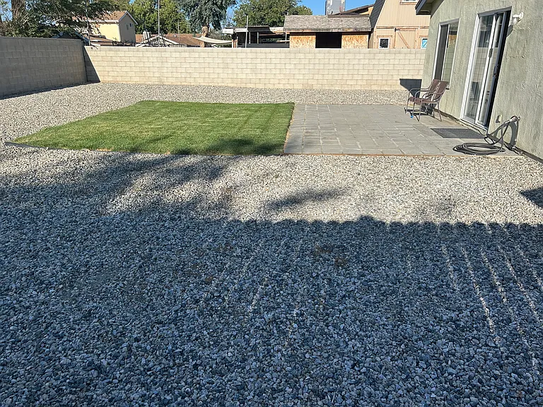 BACK YARD HAS SMALL GRASS AREA AND STEPPING STONES
