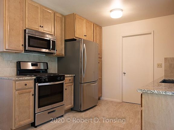 New kitchen with vented OTR microwave.