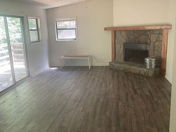 Front Room with wood burning fireplace, access to large deck and cable.