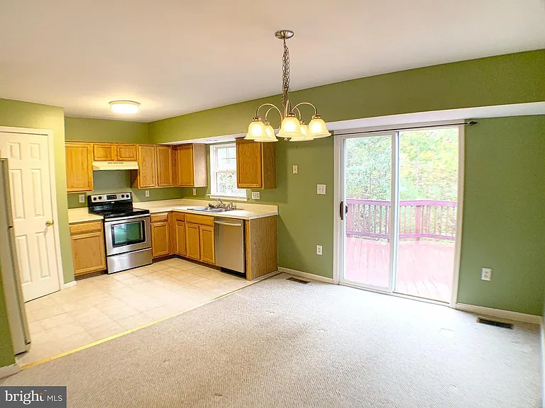 Main level: Kitchen with open family room/daily dining room. Access to the Deck.