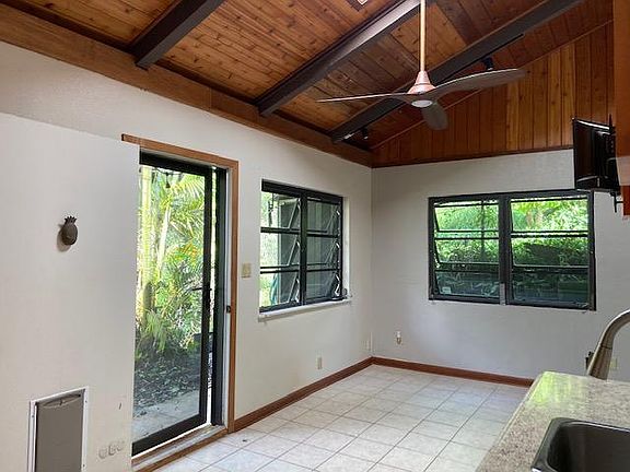 Living area: This picture was taken from the Kitchen sink looking toward the living area (also, a picture w/a a red sofa is the same space for scale) Living area...screened door and a solid door with a dog door installed; also closable. The entire area fr